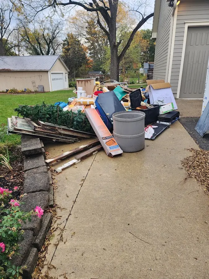 Dumpster being loaded with debris for 12 Yard Dumpster Rental in Mayfield Heights